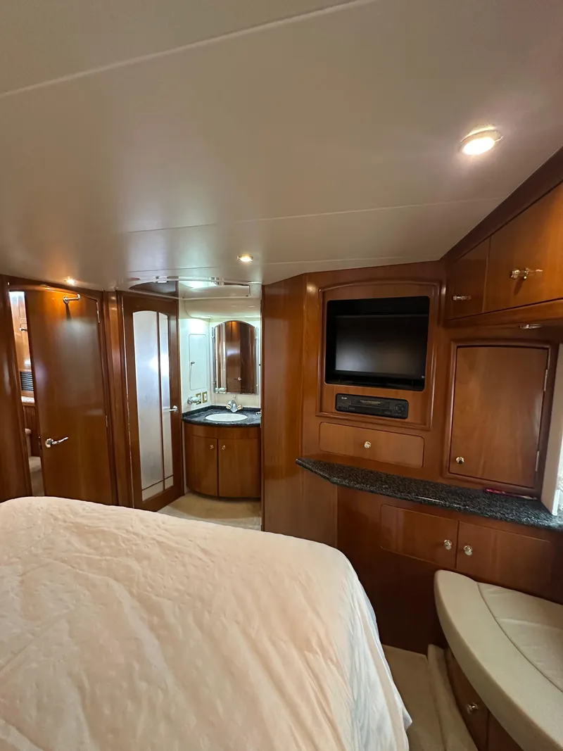 Slide: The Image of Interior of 2000 Carver 506 Motor Yacht with wood cabinetry and built-in TV. - 28