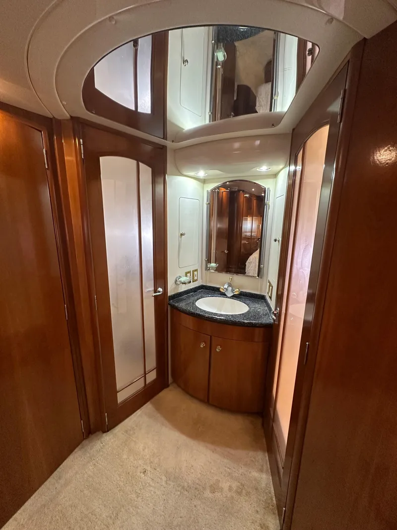 Slide: The Image of Luxurious bathroom interior of 2000 Carver 506 Motor Yacht with wood finishes and mirrored cabinets. - 29