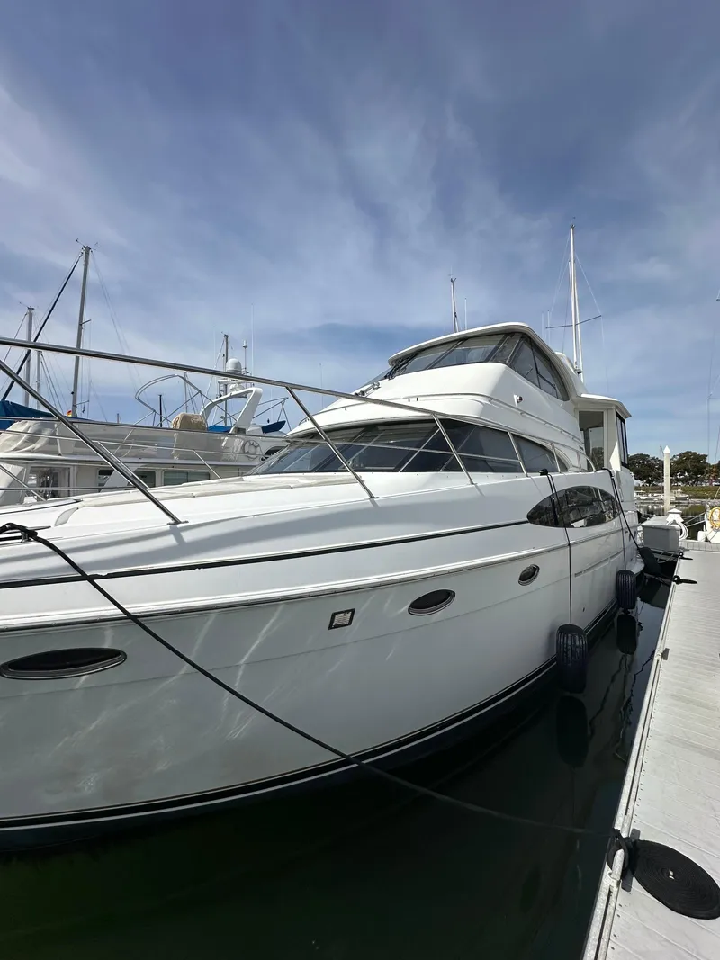 Slide: The Image of 2000 Carver 506 Motor Yacht docked at marina under clear sky. - 3
