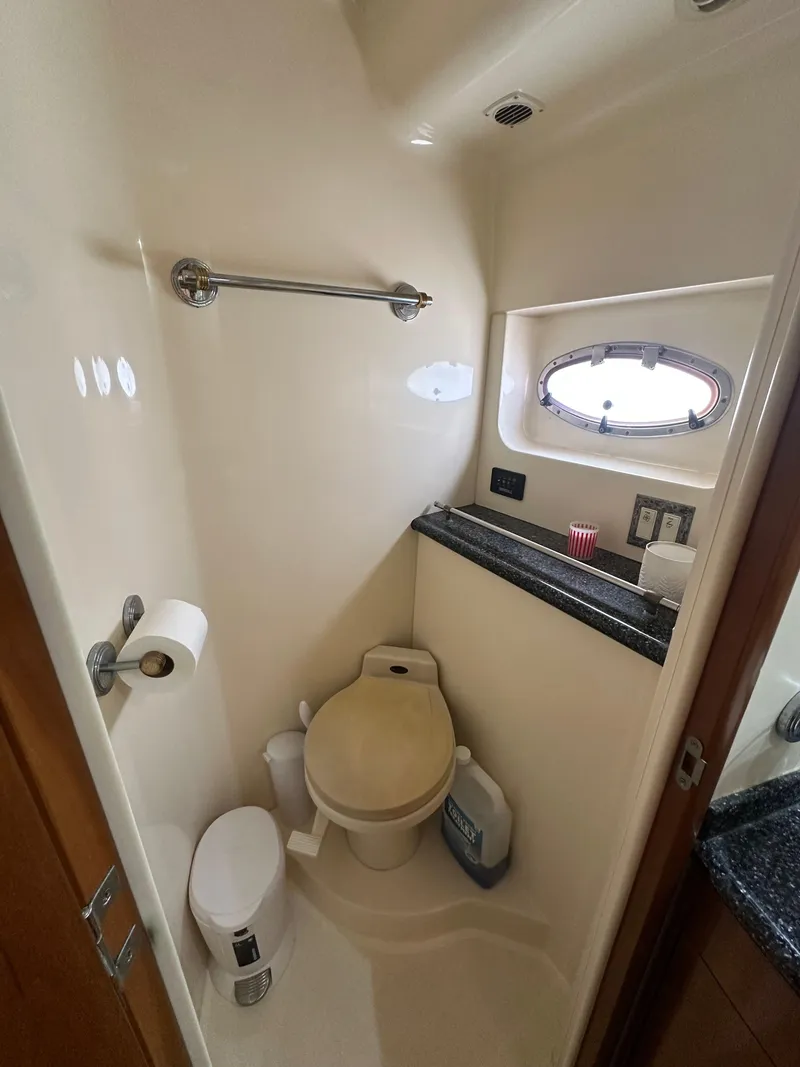 Slide: The Image of Bathroom interior of 2000 Carver 506 Motor Yacht with toilet and porthole window. - 30