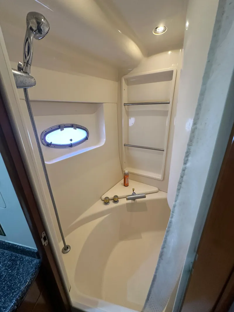 Slide: The Image of Shower area in 2000 Carver 506 Motor Yacht with porthole and shelving. - 31