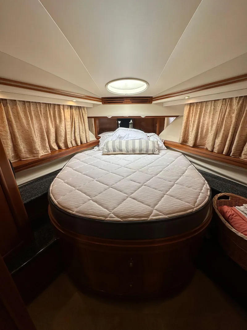 Slide: The Image of Luxurious bedroom interior of 2000 Carver 506 Motor Yacht with elegant bedding and curtains. - 34