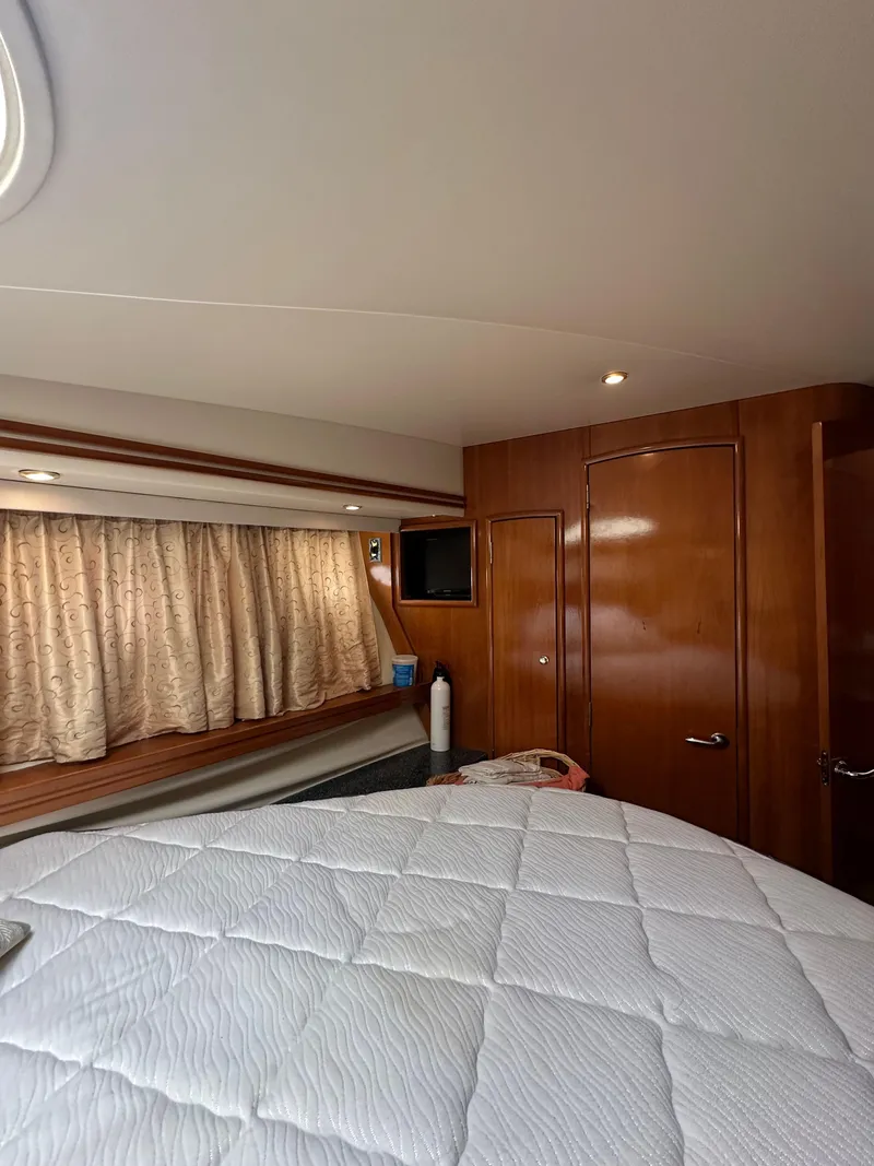 Slide: The Image of Interior of 2000 Carver 506 Motor Yacht with cozy bedroom and wooden cabinetry. - 35