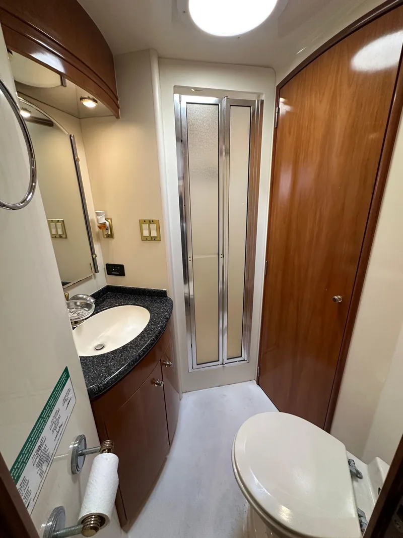 Slide: The Image of Luxurious bathroom in 2000 Carver 506 Motor Yacht with modern fixtures and wood accents. - 36