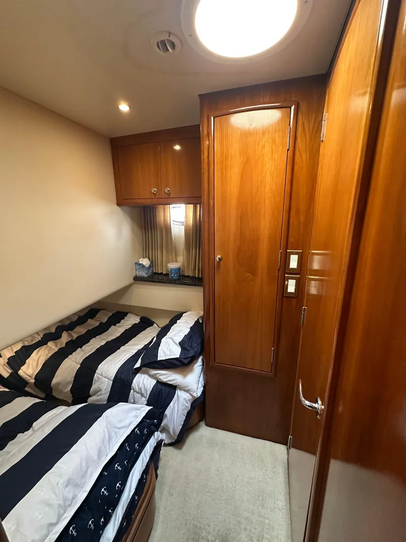 Slide: The Image of Interior of 2000 Carver 506 Motor Yacht with twin beds and wooden cabinetry. - 38