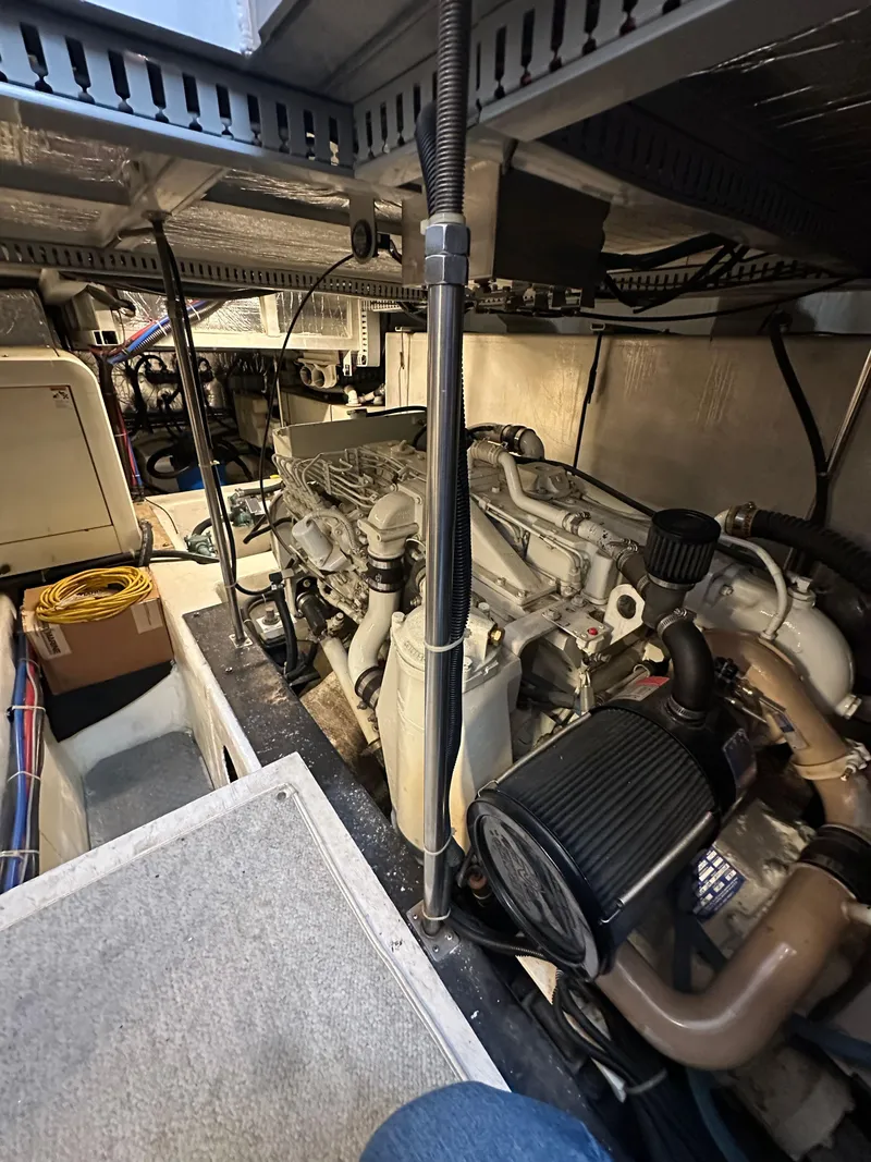 Slide: The Image of Engine room of a 2000 Carver 506 Motor Yacht, showcasing mechanical components and wiring. - 42
