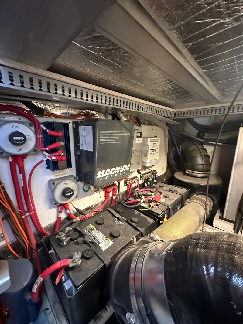 Slide: The Image of Engine room of 2000 Carver 506 Motor Yacht with batteries and wiring. - 49