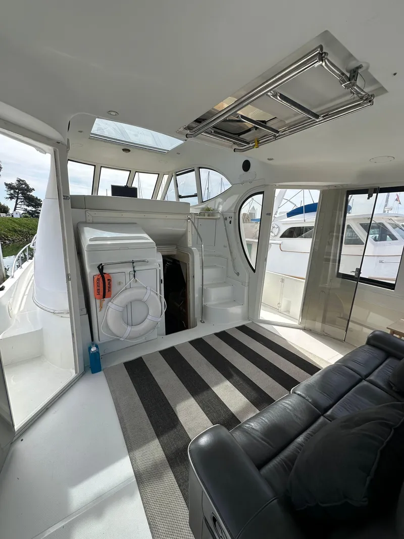 Slide: The Image of Interior of 2000 Carver 506 Motor Yacht with modern seating and striped rug. - 7