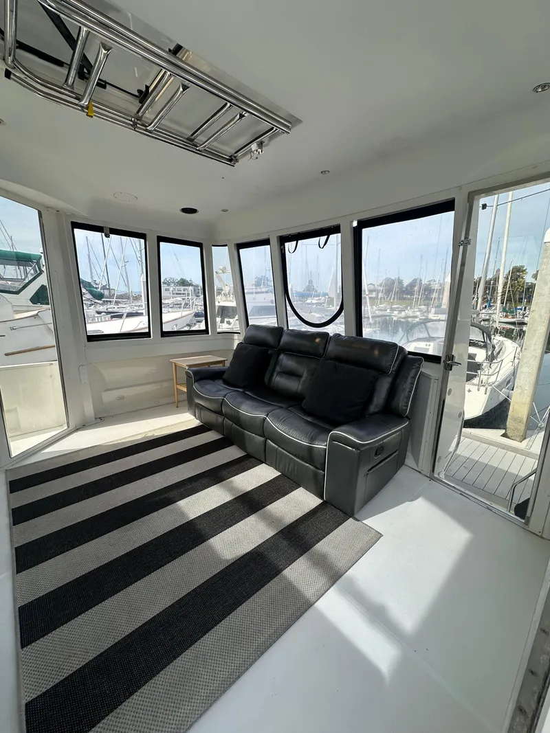 Slide: The Image of Interior of 2000 Carver 506 Motor Yacht with leather sofa and striped rug. - 9