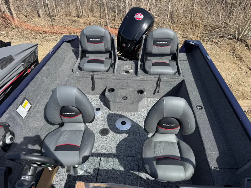 Slide: The Image of 2025 Tracker Pro Guide V-175 Combo boat interior with four seats and motor. - 10