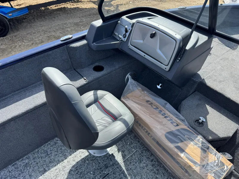 Slide: The Image of 2025 Tracker Pro Guide V-175 Combo boat interior with gray seating and dashboard. - 11