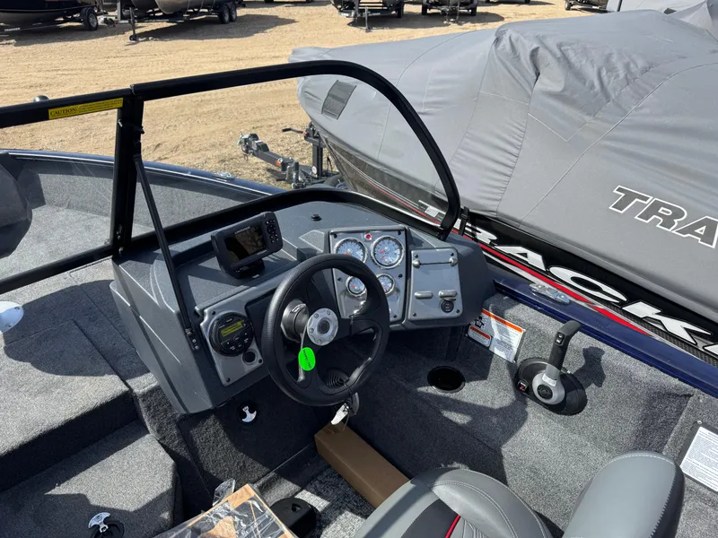 Slide: The Image of 2025 Tracker Pro Guide V-175 Combo boat interior with steering wheel and control panel. - 13