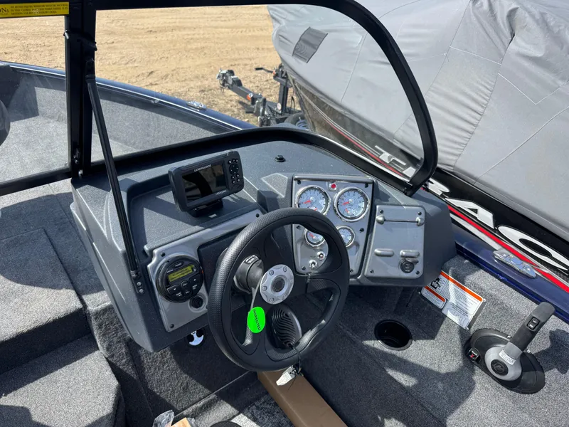 Slide: The Image of 2025 Tracker Pro Guide V-175 Combo boat dashboard with steering wheel and gauges. - 15