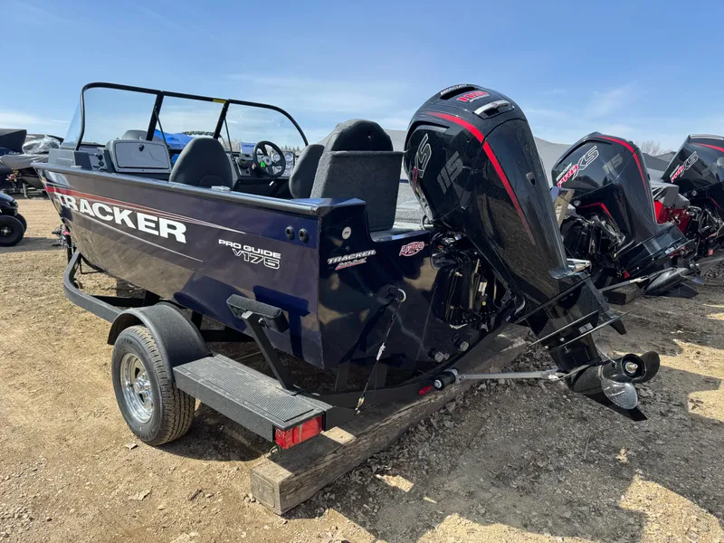 Slide: The Image of 2025 Tracker Pro Guide V-175 Combo boat on trailer, featuring powerful outboard motor. - 2