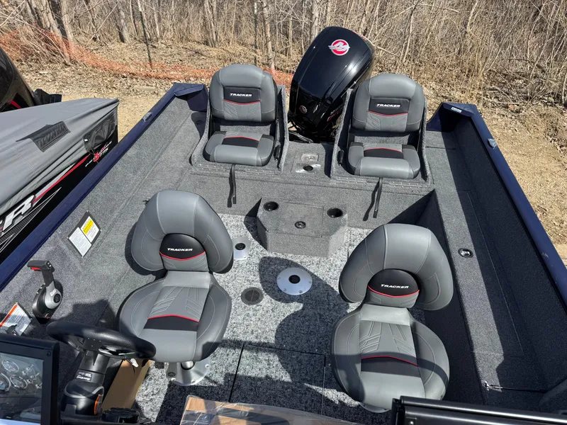 Slide: The Image of 2025 Tracker Pro Guide V-175 Combo boat interior with four gray seats and motor. - 8
