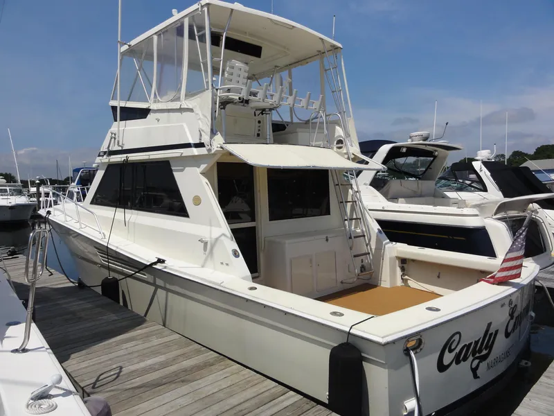 The Image of 1990 Viking 45 Convertible yacht docked at marina, featuring spacious deck and flybridge. - 0