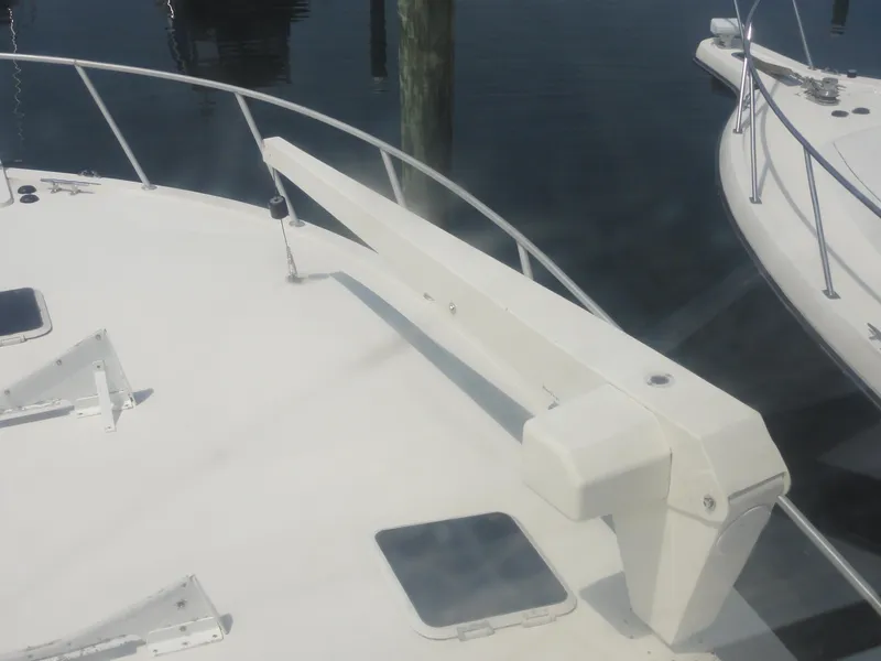 Slide: The Image of Bow of a 1990 Viking 45 Convertible yacht with railing and deck features. - 11
