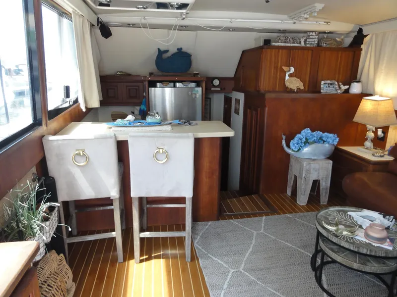 Slide: The Image of Interior of a 1990 Viking 45 Convertible yacht with cozy seating and decor. - 14