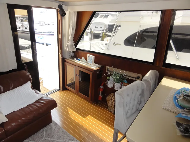 Slide: The Image of Interior of 1990 Viking 45 Convertible yacht with leather seating and wooden flooring. - 16