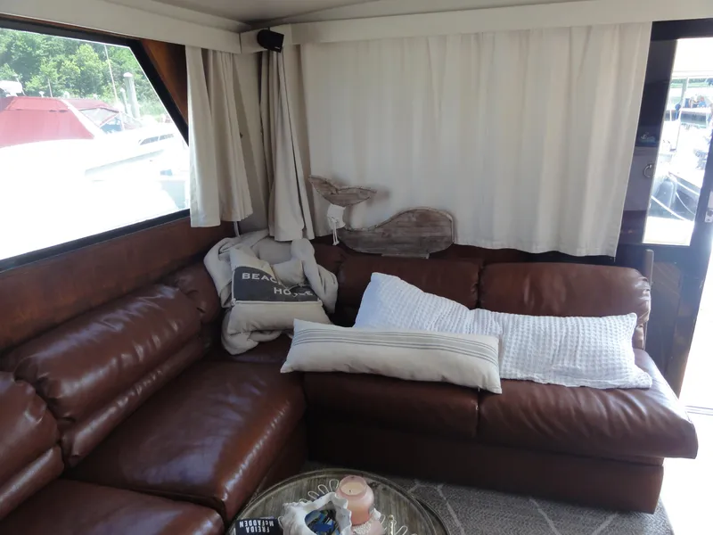 Slide: The Image of Cozy interior of 1990 Viking 45 Convertible yacht with leather seating and nautical decor. - 17