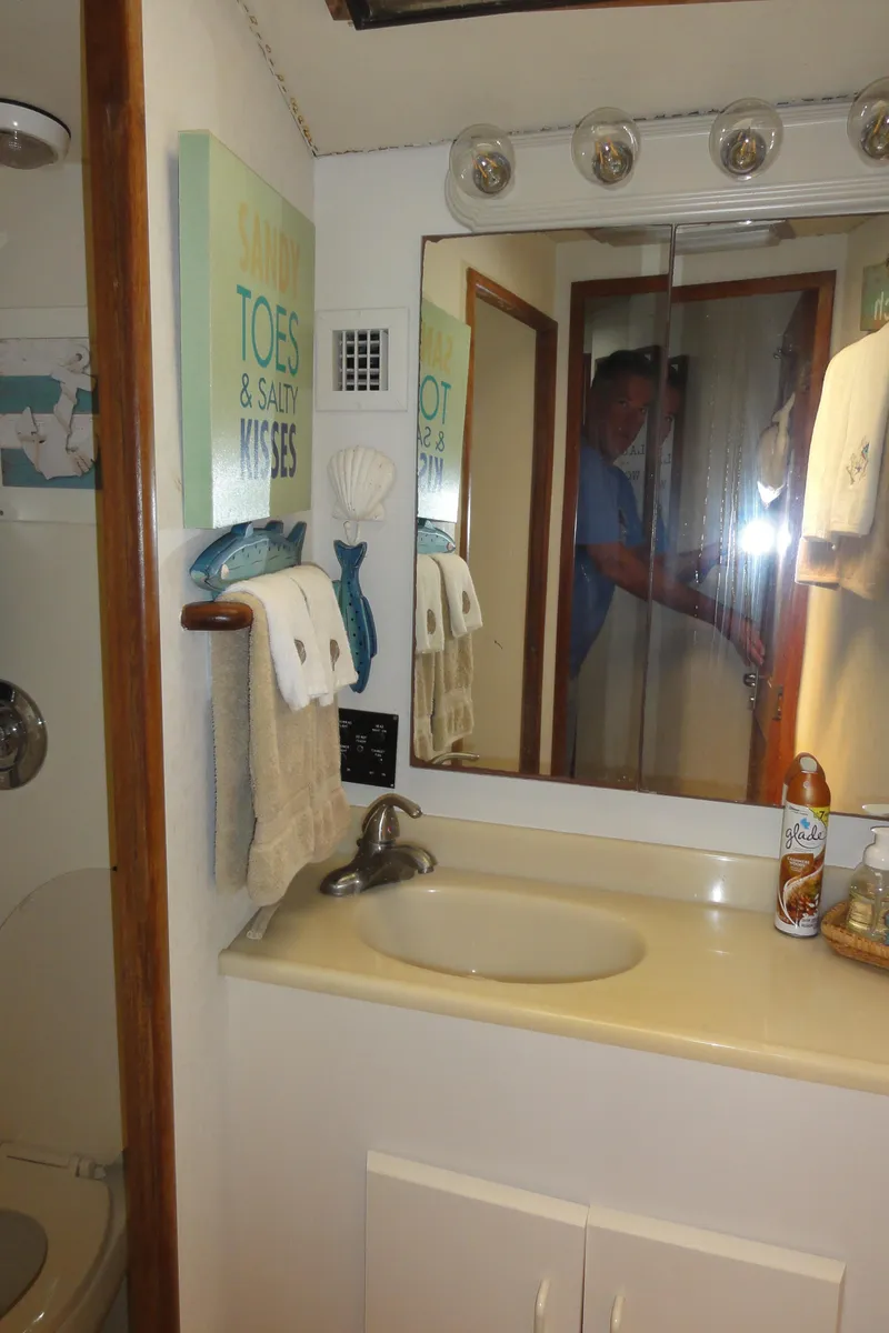 Slide: The Image of Bathroom interior of 1990 Viking 45 Convertible yacht with sink and mirror. - 22