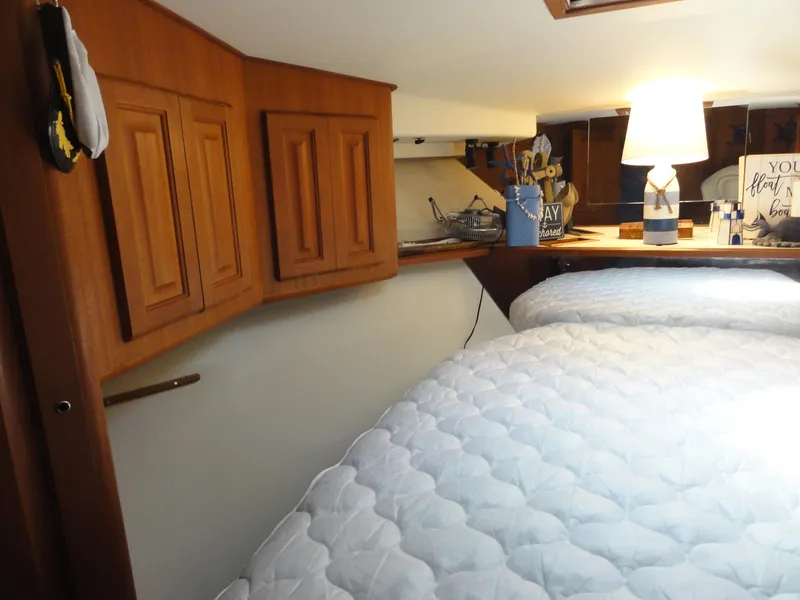 Slide: The Image of Cozy cabin interior of 1990 Viking 45 Convertible yacht with wooden cabinets and soft lighting. - 23