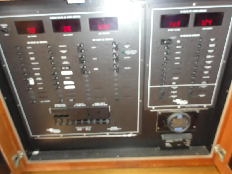Slide: The Image of Control panel of a 1990 Viking 45 Convertible boat with various switches and displays. - 27