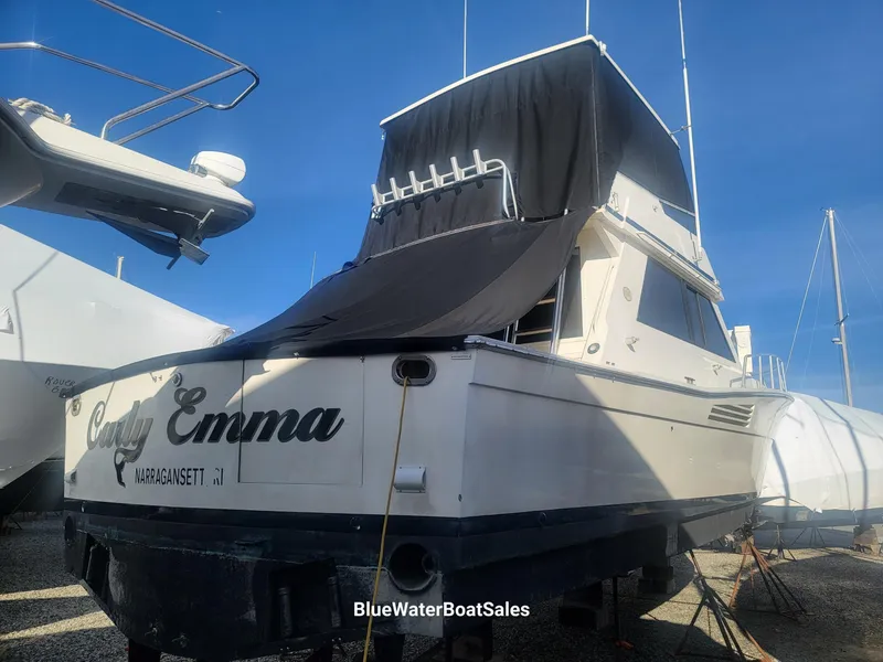 Slide: The Image of 1990 Viking 45 Convertible boat, named "Lady Emma," on display at BlueWater Boat Sales. - 4