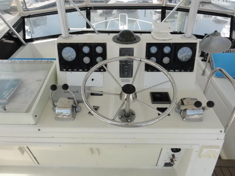 Slide: The Image of 1990 Viking 45 Convertible boat helm with steering wheel and control panel. - 7