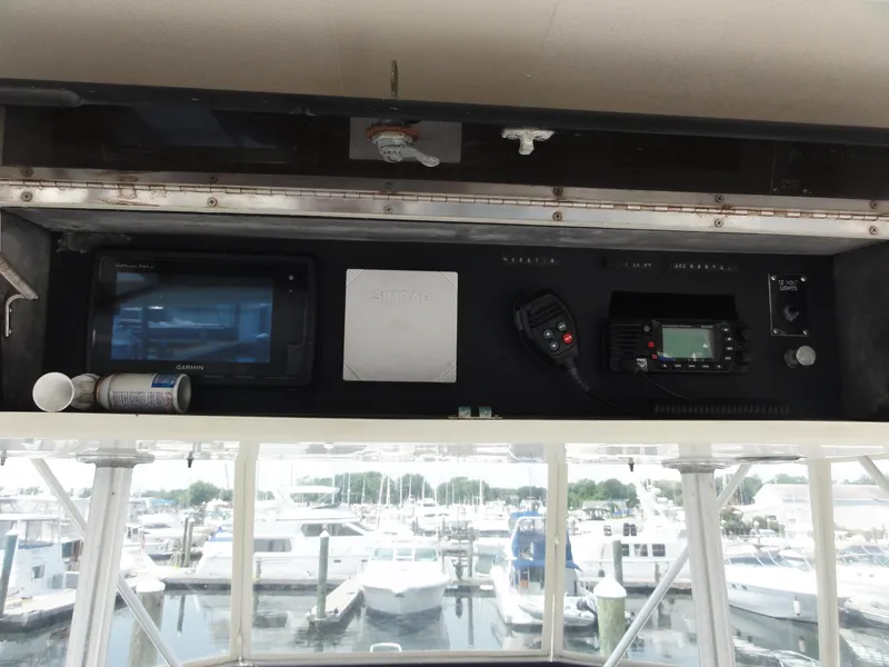 Slide: The Image of 1990 Viking 45 Convertible boat dashboard with navigation and communication equipment. - 8