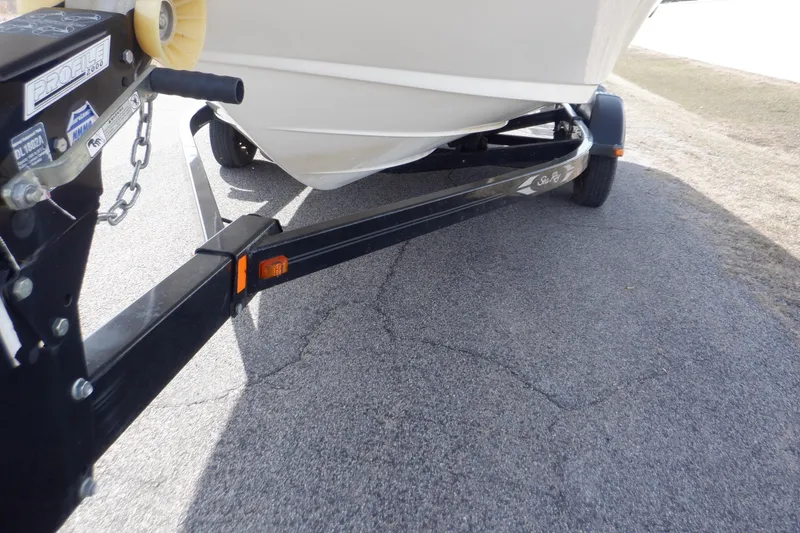 Slide: The Image of 2012 Sea Ray 205 Sport boat on trailer, parked on asphalt. - 10