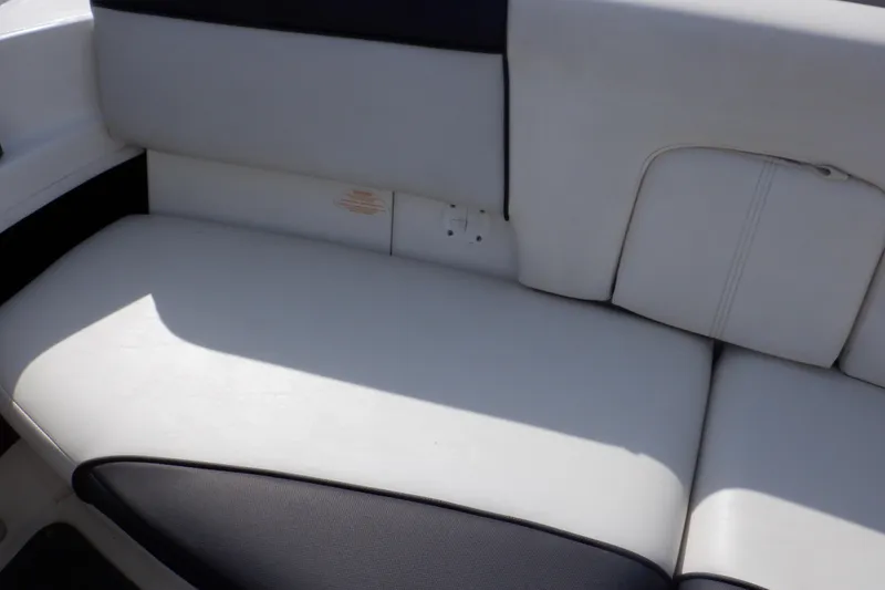 Slide: The Image of 2012 Sea Ray 205 Sport boat interior seating, white and black upholstery. - 16