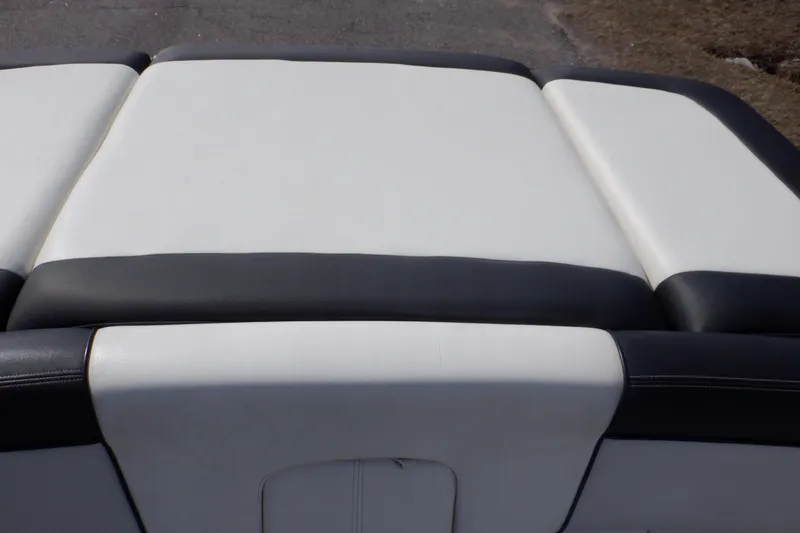 Slide: The Image of 2012 Sea Ray 205 Sport boat seat, white and black upholstery. - 17