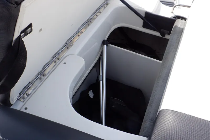 Slide: The Image of Open storage compartment in 2012 Sea Ray 205 Sport boat. - 19