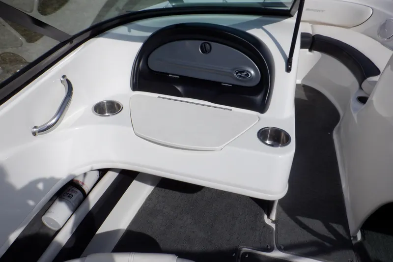 Slide: The Image of 2012 Sea Ray 205 Sport boat interior with dashboard and cup holders. - 23