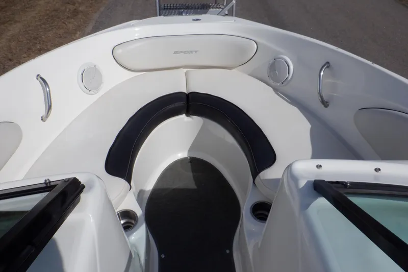 Slide: The Image of 2012 Sea Ray 205 Sport boat interior with cushioned seating and speakers. - 25
