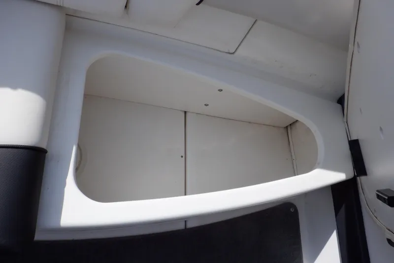 Slide: The Image of Storage compartment in a 2012 Sea Ray 205 Sport boat interior. - 28