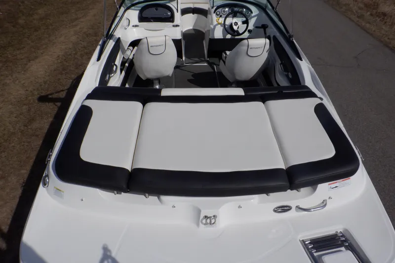 Slide: The Image of 2012 Sea Ray 205 Sport boat interior with white and black seating. - 3