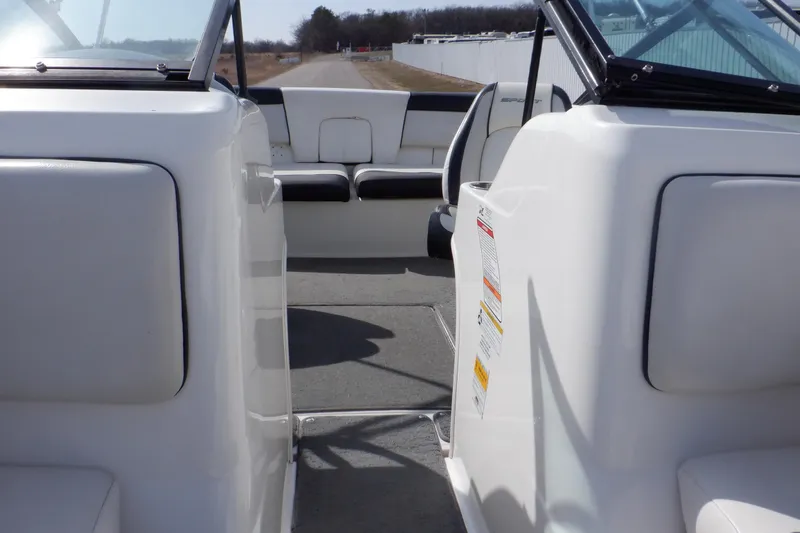 Slide: The Image of Interior view of a 2012 Sea Ray 205 Sport boat, showcasing seating and open deck. - 36