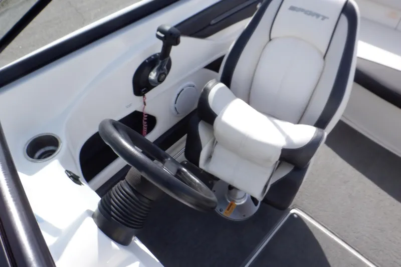 Slide: The Image of Interior of 2012 Sea Ray 205 Sport boat showing steering wheel and captain's chair. - 39