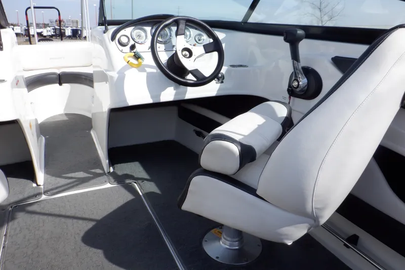 Slide: The Image of 2012 Sea Ray 205 Sport boat interior with steering wheel and seating. - 41