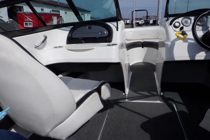 Slide: The Image of Interior of 2012 Sea Ray 205 Sport boat with white seating and dashboard. - 42