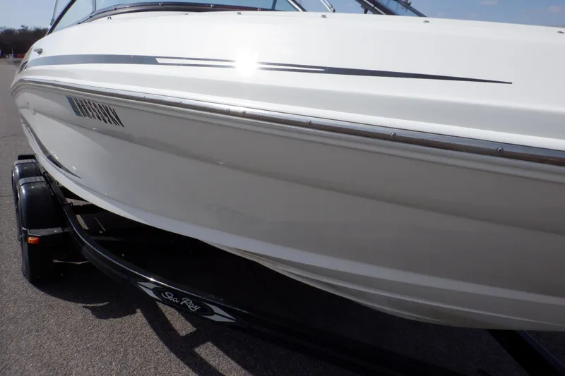 Slide: The Image of 2012 Sea Ray 205 Sport boat on trailer, side view, white exterior. - 43