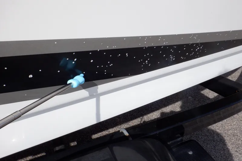 Slide: The Image of Cleaning the hull of a 2012 Sea Ray 205 Sport boat with a pressure washer. - 46