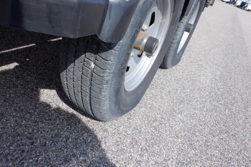 Slide: The Image of Close-up of trailer wheels on asphalt, related to 2012 Sea Ray 205 Sport. - 49