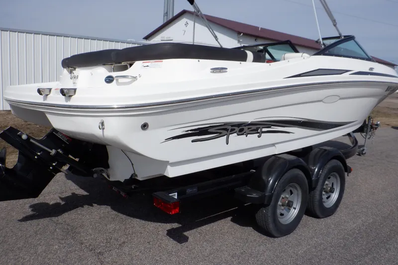 Slide: The Image of 2012 Sea Ray 205 Sport boat on a trailer, parked outdoors. - 5