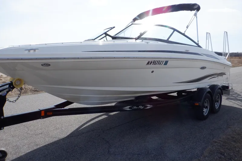 Slide: The Image of 2012 Sea Ray 205 Sport boat on trailer, parked on a road. - 9