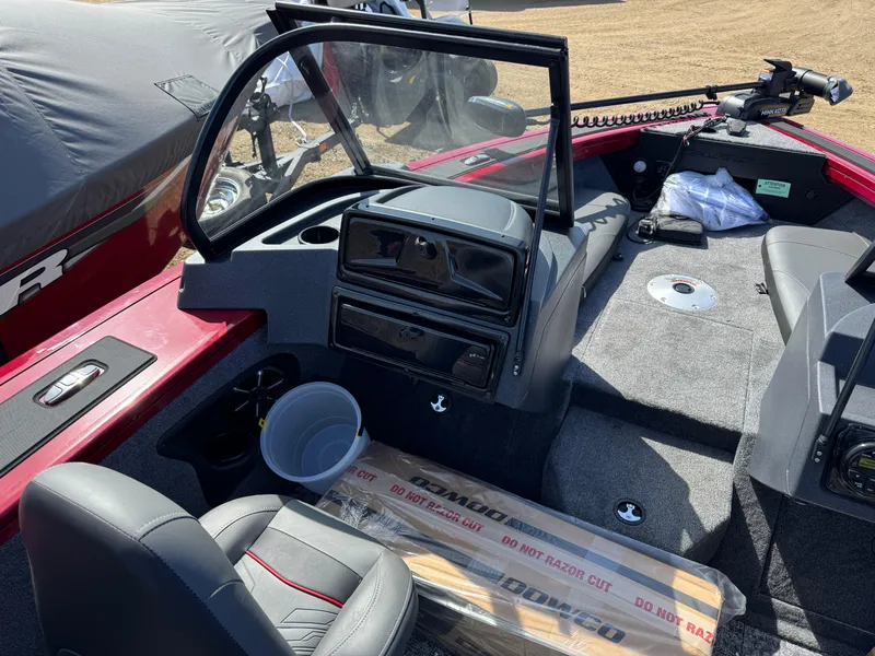 Slide: The Image of 2025 Tracker Targa V-18 Combo boat interior with seating, steering console, and storage. - 11