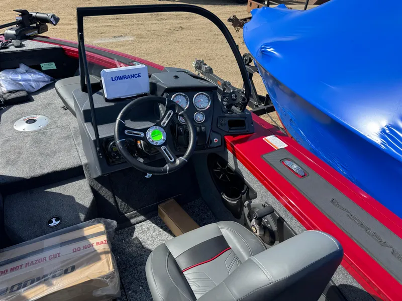 Slide: The Image of 2025 Tracker Targa V-18 Combo boat interior with steering wheel and Lowrance display. - 12