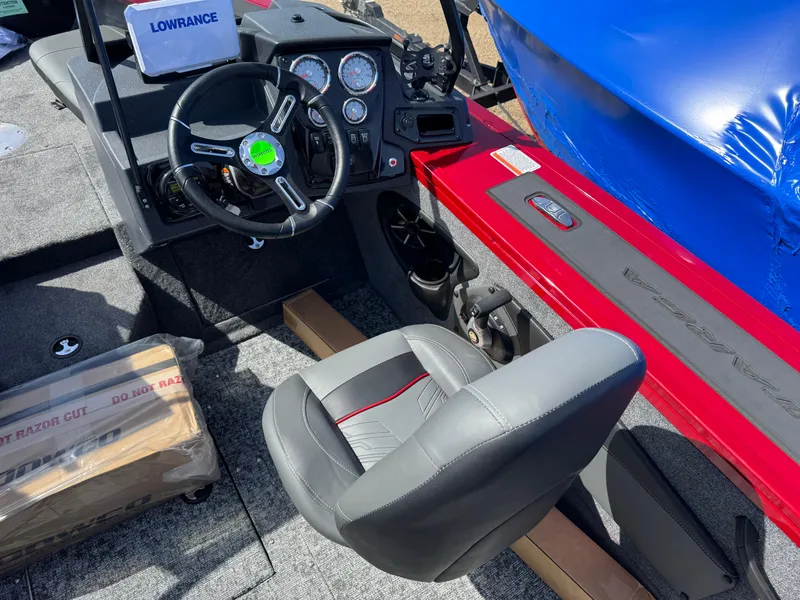 Slide: The Image of 2025 Tracker Targa V-18 Combo boat interior with steering wheel and seat. - 13